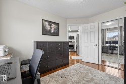 Interior room featuring wood-finish flooring and light neutral wall paint - 