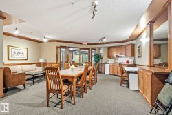 Spacious common area featuring wood-finish trim, neutral wall tones, and track lighting - 