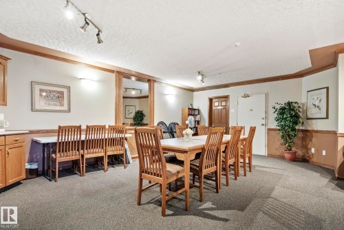 Spacious communal area featuring track lighting, wood-finish trim, and durable carpet flooring - 421 9730 174 Street, Edmonton, AB 