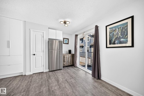 Open concept living area featuring contemporary wood-finish flooring - 146 5604 199 Street, Edmonton, AB 