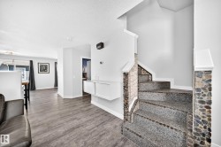 Stone-clad staircase featuring mosaic pebble detailing and granite-finish treads - 