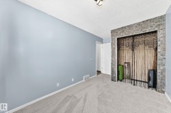 Carpeted room featuring light blue painted walls and a textured ceiling - 