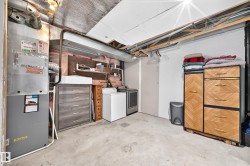 Dedicated utility area with concrete flooring, exposed ceiling joists, and a visible HVAC unit - 