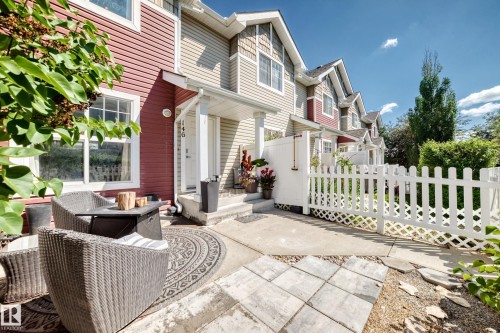 Exterior of a multi-level townhouse featuring red and beige siding - 146 5604 199 Street, Edmonton, AB 