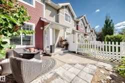 Exterior of a multi-level townhouse featuring red and beige siding - 