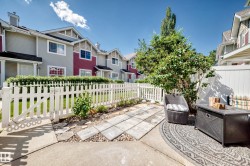 Private outdoor patio area featuring concrete and stone paver flooring - 
