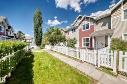 Townhome exterior featuring multi-toned siding, white trim windows, and a covered entry - 