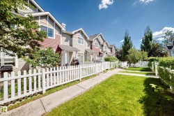 Townhome exterior featuring varied siding materials, gabled rooflines, and individual covered entrances - 