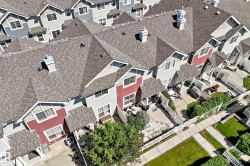 Contemporary townhome-style residences featuring pitched shingle roofing and varied exterior finishes - 