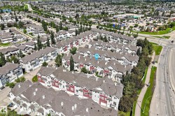 Aerial perspective showcasing a community of multi-story townhomes with varying exterior colors - 