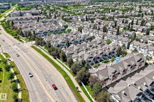 Aerial perspective showcasing a residential community with multi-level townhomes - 146 5604 199 Street, Edmonton, AB 
