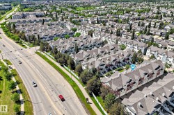 Aerial perspective showcasing a residential community with multi-level townhomes - 