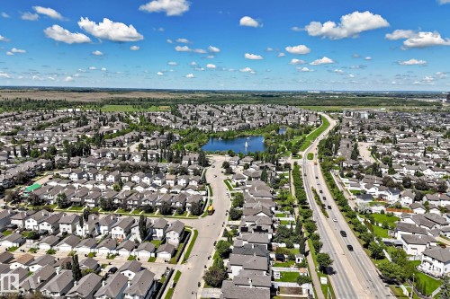Aerial perspective showcasing a residential community with a central lake - 146 5604 199 Street, Edmonton, AB 