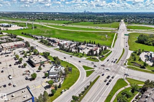 Aerial perspective showcasing a multi-lane intersection with multiple commercial buildings - 146 5604 199 Street, Edmonton, AB 