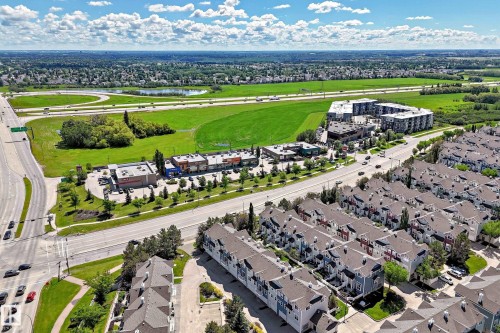 Aerial perspective showcasing a residential community with multi-story townhomes and apartment buildings - 146 5604 199 Street, Edmonton, AB 