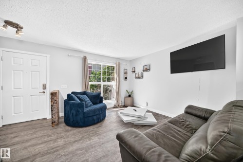 Living space featuring light gray walls and wood-finish flooring - 146 5604 199 Street, Edmonton, AB 