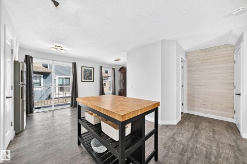 Kitchen island with a butcher block countertop and open shelving - 146 5604 199 Street, Edmonton, AB 