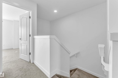 Upper level hallway featuring plush carpet flooring and recessed lighting - 1208 14 Ave Nw, Edmonton, AB 