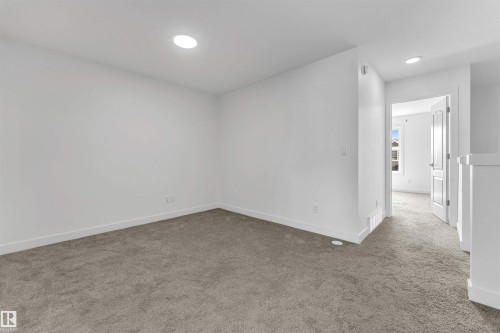 Carpeted room with recessed lighting and crisp white walls - 1208 14 Ave Nw, Edmonton, AB 