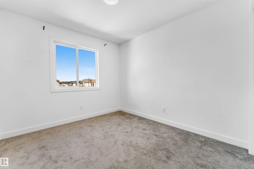 Neutral white walls complement the gray carpeting - 1208 14 Ave Nw, Edmonton, AB 