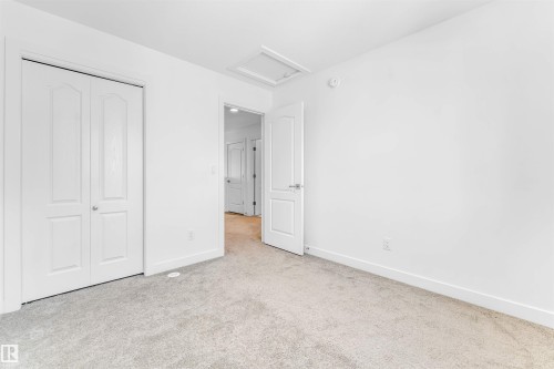 Room featuring light gray carpeting, white walls, and white baseboards - 1208 14 Ave Nw, Edmonton, AB 