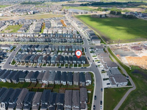 Aerial view showcasing a residential development with structured street layouts and consistent house designs - 1208 14 Ave Nw, Edmonton, AB 