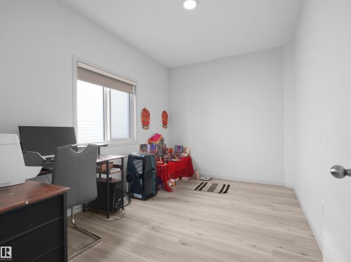 Bright room featuring light wood-finish flooring, white walls, a recessed ceiling light, and a window with blinds - 4615 175 Avenue, Edmonton, AB 