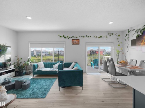 Open concept living area featuring wood-finish flooring and recessed lighting - 4615 175 Avenue, Edmonton, AB 