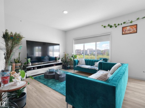 Living space featuring wood-finish flooring and recessed lighting - 4615 175 Avenue, Edmonton, AB 
