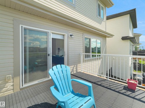 Exterior deck featuring gray composite decking and white metal railing - 4615 175 Avenue, Edmonton, AB 