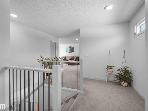 Upper level hallway featuring light gray carpeting and recessed lighting - 4615 175 Avenue, Edmonton, AB 