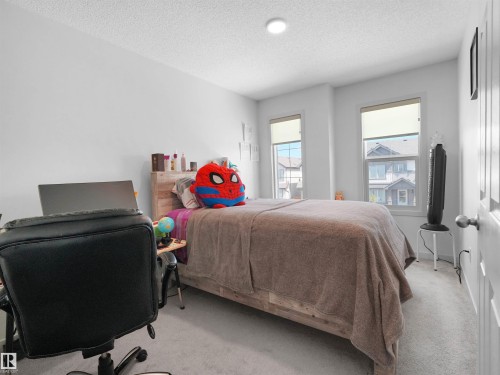 Neutral-toned interior room featuring light gray carpet flooring - 4615 175 Avenue, Edmonton, AB 