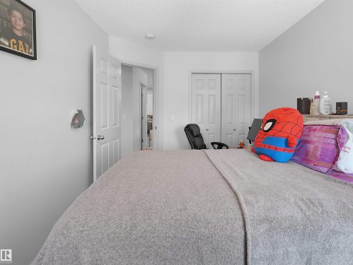 White walls complemented by white trim and a textured ceiling - 4615 175 Avenue, Edmonton, AB 