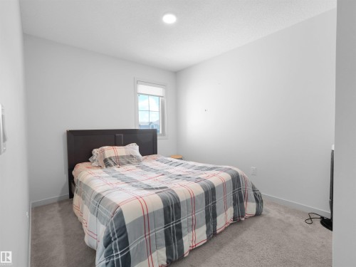 Bedroom featuring light gray carpet flooring, white walls, and a recessed ceiling light - 4615 175 Avenue, Edmonton, AB 