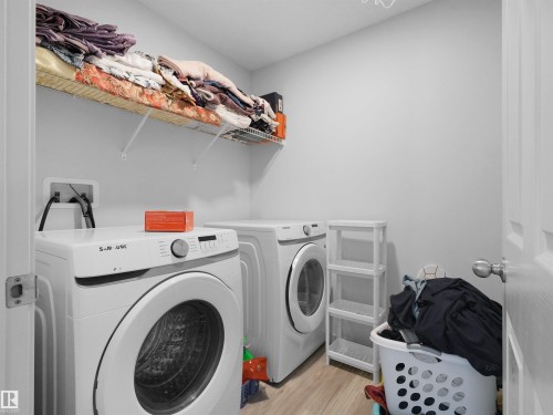 Dedicated laundry area featuring light wood-finish flooring and neutral wall tones - 4615 175 Avenue, Edmonton, AB 