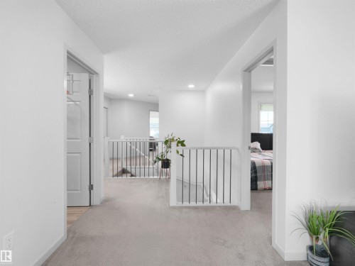 Spacious hallway with light gray carpeting and white walls - 4615 175 Avenue, Edmonton, AB 