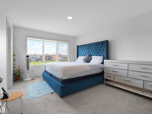 Carpeted interior space featuring a large window, recessed lighting, and white walls - 4615 175 Avenue, Edmonton, AB 