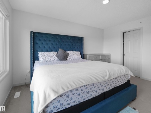 Bright room featuring a window, light-colored walls, and carpet flooring - 4615 175 Avenue, Edmonton, AB 