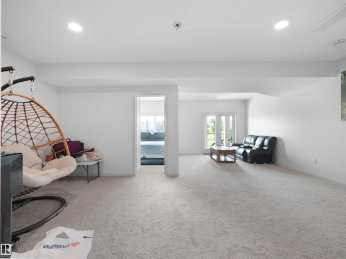 Spacious interior with neutral carpeting and recessed lighting - 4615 175 Avenue, Edmonton, AB 