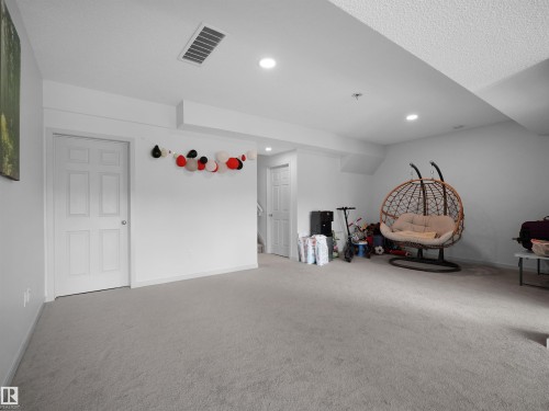 Carpeted room with recessed lighting and white walls - 4615 175 Avenue, Edmonton, AB 