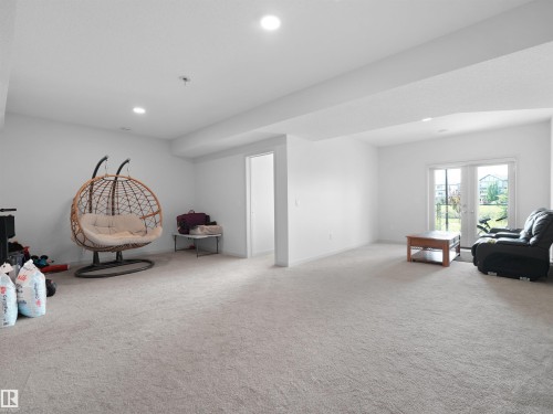 Spacious lower-level room featuring light-toned carpeting and recessed ceiling lighting - 4615 175 Avenue, Edmonton, AB 