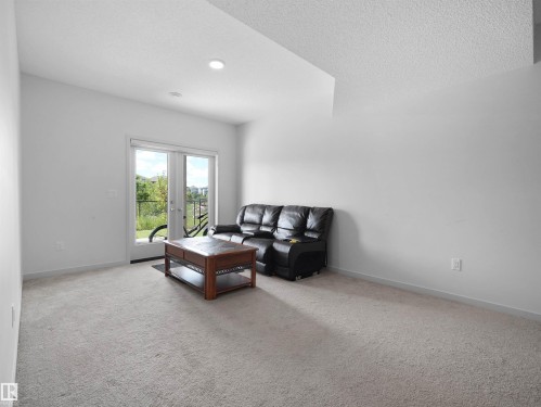 Spacious room featuring light gray carpeting and white walls - 4615 175 Avenue, Edmonton, AB 