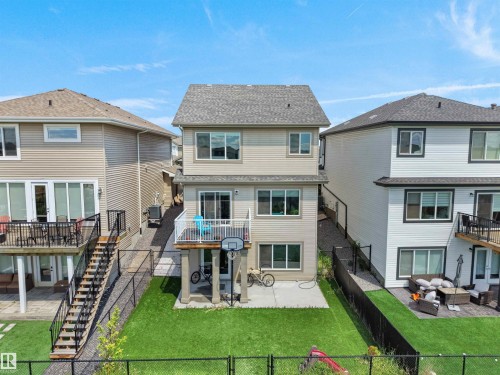 Two-story residential exterior featuring a light-colored siding facade and a dark shingle roof - 4615 175 Avenue, Edmonton, AB 