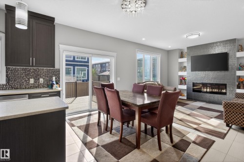 8607 Mayday Wynd, Edmonton, AB - Indoor Photo Showing Dining Room With Fireplace