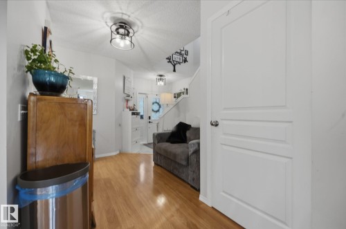 Wood-finish flooring throughout the entryway - 60 Leyland Way, Spruce Grove, AB 