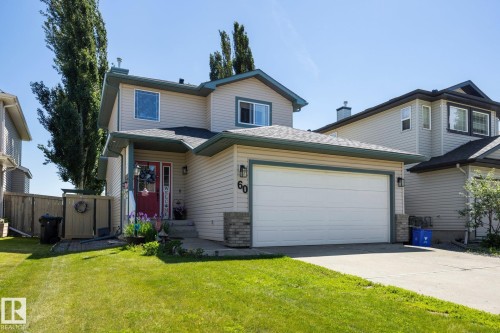 Two-story residence featuring light-colored siding with dark trim accents - 60 Leyland Way, Spruce Grove, AB 