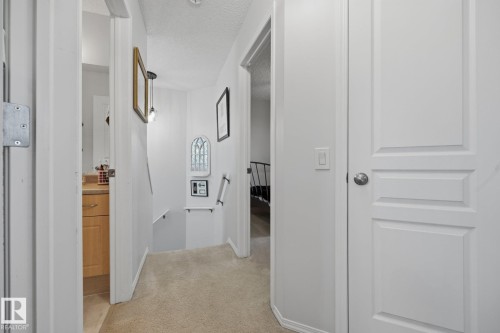Hallway with light-toned carpet flooring, white painted walls, and recessed lighting - 60 Leyland Way, Spruce Grove, AB 