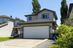 Siding exterior with complementary trim, attached garage, and concrete driveway - 