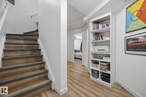 Wood-finish stairs with gray risers and a white handrail - 60 Leyland Way, Spruce Grove, AB 