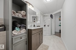 Contemporary bathroom featuring a wood-finish vanity with a white countertop and rectangular undermount sink - 